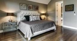 Bedroom in neutral color palette including bed with headboard